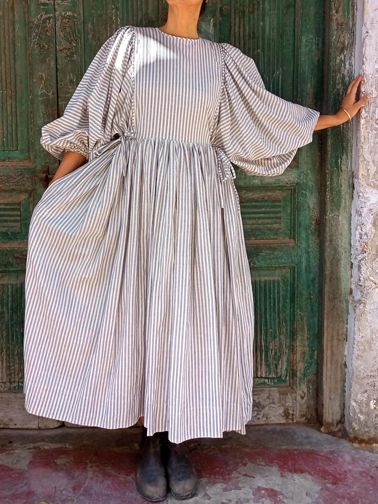 Organic cotton striped meadow dress showing full gathered skirt and soft movement, Victorian-inspired handmade design.