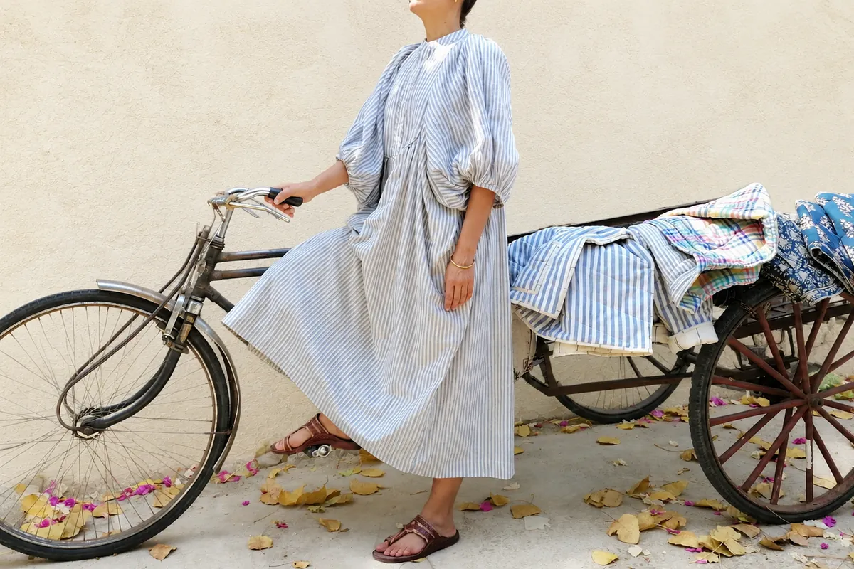 Alt text: Cotton Conscious organic cotton clothing with a bicycle in Rishikesh, India